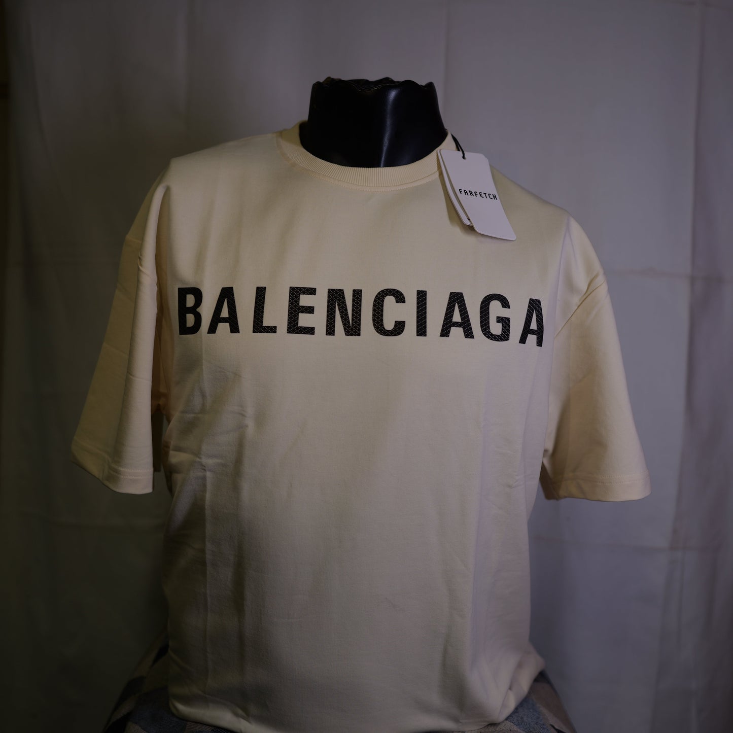 Beige Balenciaga t-shirt on a mannequin with a white background