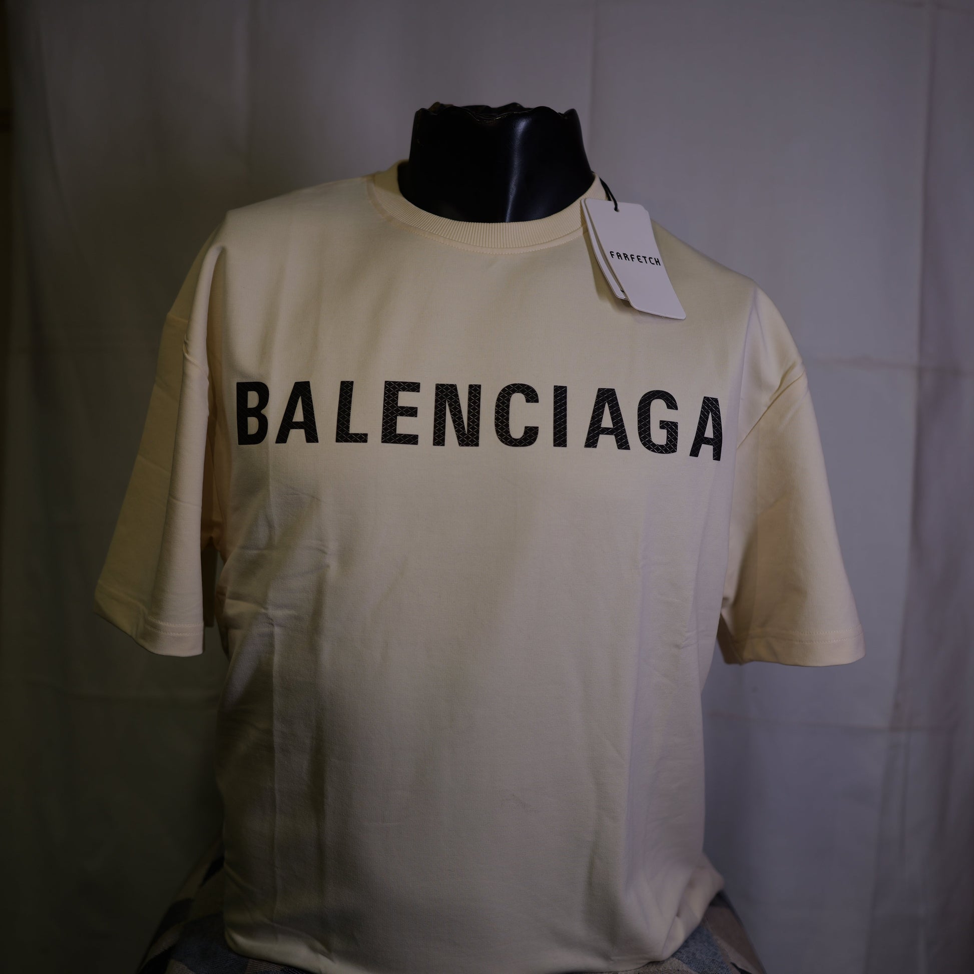 Beige Balenciaga t-shirt on a mannequin with a white background
